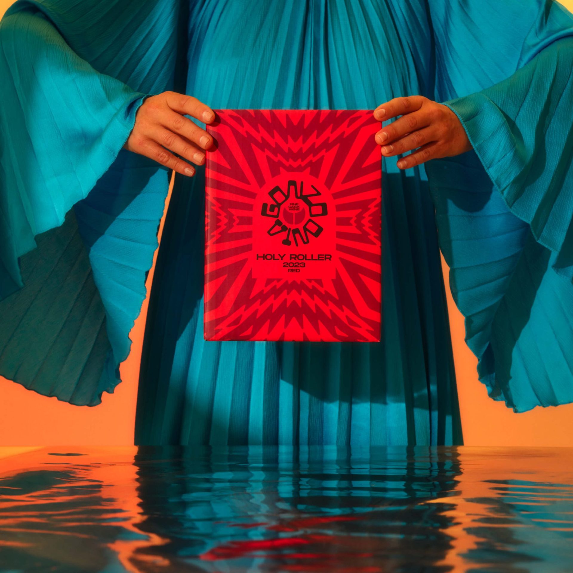 a cask of gonzo vino holy roller red wine being held by a woman in a turquoise dress